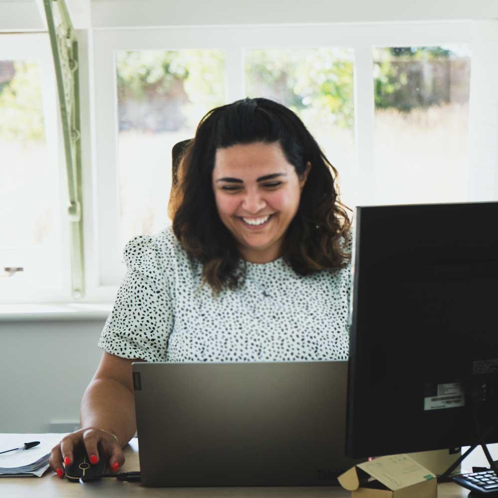 Woman-smiling-at-desk.jpg